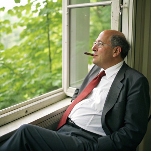 Gregor Gysi, the renowned politician, captured in a relaxed pose. White shirt, dark grey suit, red tie. Smoking a cigar. Sitting by a window with natural light. Lively green foliage outside