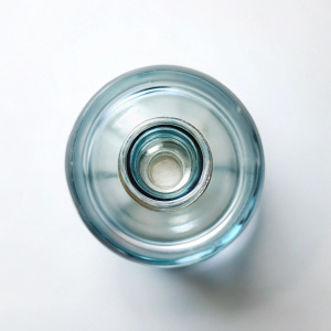 Glass water bottle top view in white background