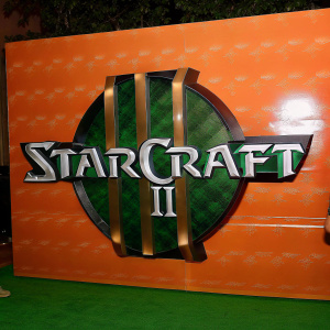Digital art piece showcasing the StarCraft II logo with a sleek, metallic finish. Teal and gold hues dominate the design, set against a dark, textured backdrop. The logo appears three-dimensional and is the focal point of the illustration.