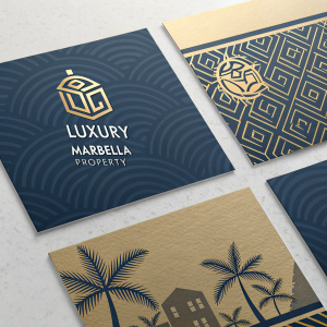 Digital design showcasing a set of business cards for Luxury Marbella Property. Modern, sophisticated look with a grid layout. Each card features the company name in bold, elegant font. Consistent color palette of deep blue and shimmering gold.