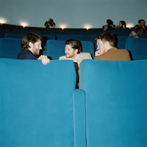 Actors Colin Morgan, Kit Harington, and Taron Egerton in a crowded auditorium. Engaged in conversation during a Q&A session at the BFI London Film Festival.