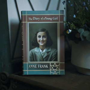 Book covers for 'The Diary of a Young Girl' by Anne Frank. Displaying a photo of the author with a cheerful and earnest expression. Cover designs in earthy tones like brown and green, alongside a vibrant array of colors.