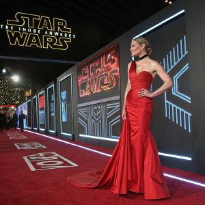 Katee Sackhoff at the launch event for the new Star Wars series. She's wearing a glamorous red gown. The backdrop features neon signs and futuristic designs.