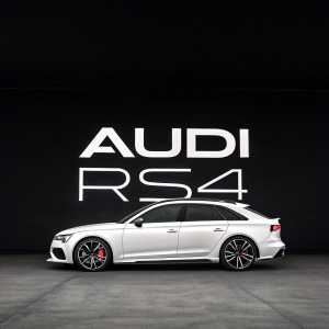 A sleek 'AUDI RS4' logo, boldly displayed in the center of the image. Modern sans-serif font against a plain black background, highlighting the simplicity and elegance.