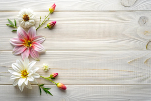 overhead view of a white wooden surface with very marked and rickety grain. On the surface are dahlias, lilies and other flowers grouped in the lower right corner. very sharp high quality image