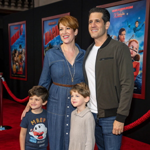 Molly Ringwald and Panio Gianopoulos at 'Wreck-It Ralph 2' premiere with their kids. Wearing casual outfits. Red carpet with movie poster backdrop