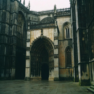 Monastery of Batalha, UNESCO World Heritage site, Portugal. Gothic architecture, stone textures, intricate carvings. Big entrance. Historical beauty. Photo.