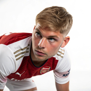 Emile Smith Rowe, intense gaze, midfield. Stark white background, close-up photo