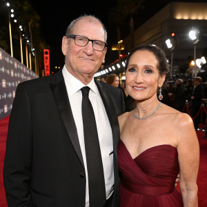 Ed O'Neill and Catherine Rusoff at the Hollywood Film Awards. Both dressed in formal attire, Ed in black tuxedo, Catherine in elegant maroon gown.