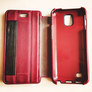 Two sleek black protective phone cases for LG Optimus F6. Featured in a detailed product photography setting.