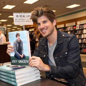 Joey Graceffa, the YouTuber, promoting his book 'In Real Life: My Journey to a Pixelated World'. Signed copies on a bookstore table