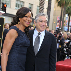 Robert De Niro and Grace Hightower at the Hollywood Walk of Fame unveiling ceremony, both elegantly dressed in formal attire.