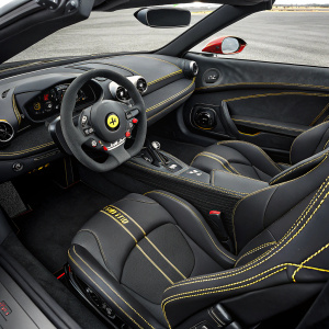 Luxury sports car, Ferrari LaFerrari Aperta. Black seats with yellow stitching. Sleek dashboard, steering wheel center stage. High-resolution photo highlights interior design.