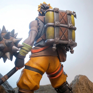 A detailed figurine of Junkrat from Overwatch, featuring vibrant colors and a dynamic pose. Set against a plain white backdrop.