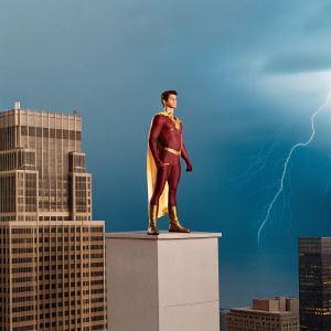 Grant Gustin in a sleek superhero suit, standing atop a Gotham City skyscraper. Dark and stormy night background