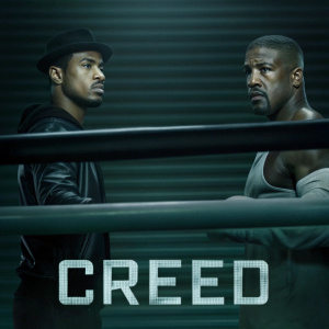 Official 'Creed' movie poster. Michael B. Jordan, Sylvester Stallone starring. Ryan Coogler directing. Dark backdrop, boxing ring center stage. Intense expressions, Michael B. Jordan's muscular build highlighted.