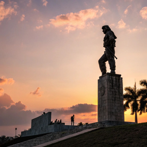 Statue of Che Guevara at sunset. Low angle shot, dark silhouette against the sky.