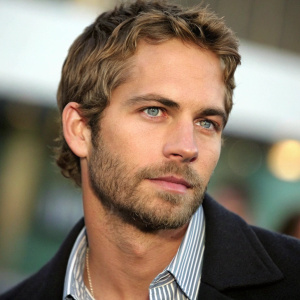 Close-up portrait of Paul Walker, fair skin, neat beard, hair, intense gaze. Dark jacket and striped shirt. High resolution, professional, blurred background.
