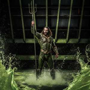 Jason Momoa, as Aquaman, in dynamic action pose. Water splashing background, CGI environment.
