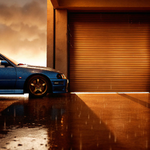 A shiny blue Nissan Skyline R34 parked outside a closed garage door. Light rain falling.