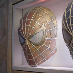 Close-up shot of Spider-Man's mask, intricate web design. White background.