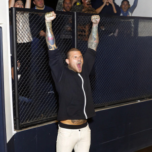 Anthony Smith celebrating victory at UFC Russia. Arms raised, showing off tattoos. Crowds cheering in the background