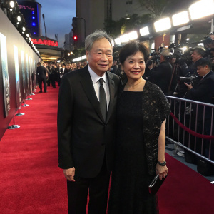 Formal photo of Ang Lee and Jane Lin at AMC Premiere for 'Billy Lynn's Long Halftime Walk'. Red carpet, flashing cameras, crowd visible in background