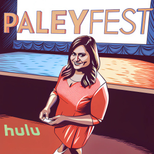 Mindy Kaling at PaleyFest, dressed in a bright pink dress and white heels. She stands in front of a dimly lit room with large hulu and PaleyFest logos.