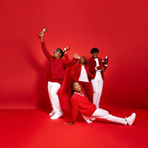 Mindless Behavior members, all dressed in casual outfits, at the Nickelodeon Kids' Choice Awards. Celebrating with awards.