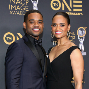 Larenz Tate and Tomasina Parrott attending the 50th NAACP Image Awards. Both dressed in formal attire, Larenz in a dark suit and Tomasina in a black dress. Standing in front of a backdrop featuring the NAACP logo.