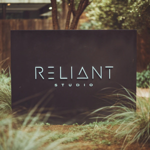 Reliant Studio logo in sleek, modern design. Black backdrop.
