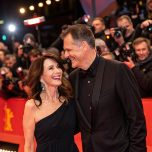 Iris Berben and Heiko Kiesow celebrating at Berlinale. Red carpet event. Crowds of paparazzi and fans in the background.