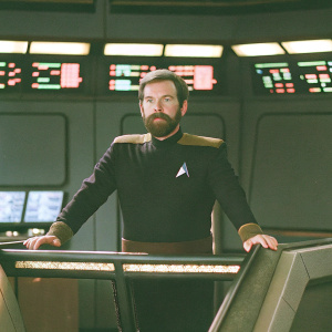 William T. Riker, starfleet captain, standing in the bridge of USS Enterprise. With his signature beard and Starfleet uniform. Futuristic setting