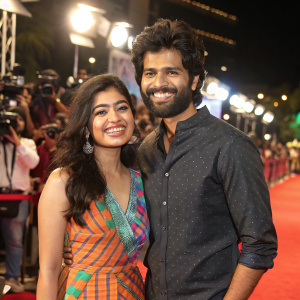 Rashmika Mandanna and Vijay Devarakonda, stars of Geetha Govindam, posing happily in front of flashing cameras.