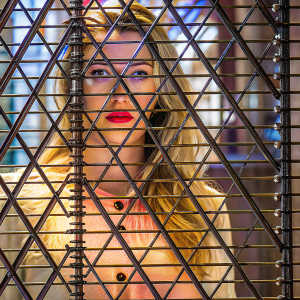 Close-up portrait of Amber Heard, Caucasian actress, long blonde hair, peach blouse, red lipstick, direct gaze, light backdrop