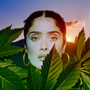 Salma Hayek, intense gaze, fair skin, prominent brows, long eyelashes, subtle expression, gold hoop earrings. Glowing sunset backdrop