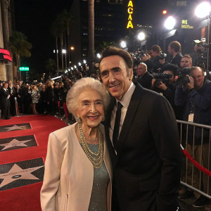 Nicolas Cage's grandmother and Joy Vogelsang posing at a celebrity-studded gala. Hollywood Walk of Fame. Crowds, flash photography