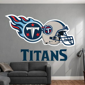A large Tennessee Titans logo wall decal on a gray living room wall. The decal features a stylized flame design and tilted Titans emblem. A smaller Titans helmet and the word 'Titans' are also present.