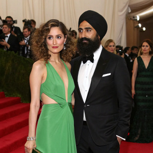 Rose Byrne and Waris Ahluwalia at the Met Gala. Rose in a stunning green gown, Waris in a black turban and tuxedo. Crowd of celebrities in the background.