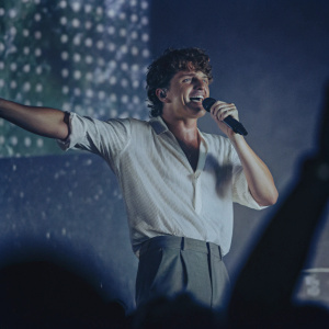 Charlie Puth, male singer with curly hair, performs at Kiiis FM and Wango Tango event. Dynamic stage background