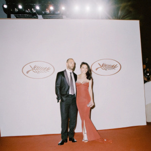 Jason Statham and Li Bingbing on the Cannes Film Festival red carpet, posing in front of large festival banners.