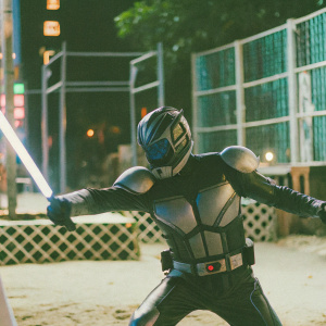 Kamen Rider Build in action pose. Sci-fi environment with glowing neon lights and metallic textures.