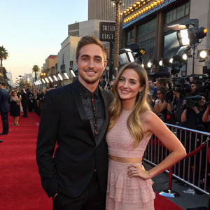 Kendall Schmidt and Micaela Von Turkovich at a Hollywood event. Red carpet with paparazzi and fans in the background.