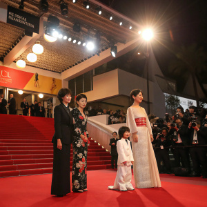 Red carpet event at Cannes Film Festival. Makiko Watanabe, Machiko Ono, Shigeki Uda, Naomi Kawase, and a child pose for photos.