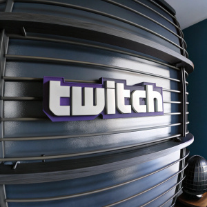 3D artwork of the Twitch logo. Sleek, modern design with bold purple and white hues. Dark blue backdrop.