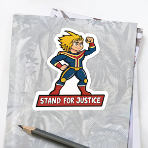 Cartoon hero sticker with muscular body, spiky blonde hair, and heroic pose. Text below reads 'Stand for Justice'. Lying on a notebook with a pencil nearby.