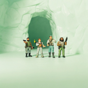 Deep Rock Galactic crew, four distinct characters. Beside a dimly lit cave entrance, surrounded by rough stone and shadows. Each character with unique features, posing together.