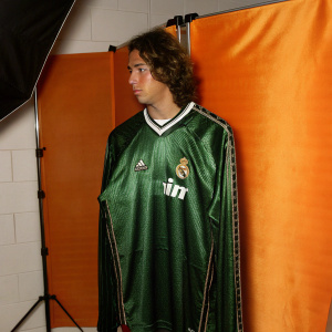 High-resolution image of a Real Madrid teal jersey. Brightly lit studio backdrop