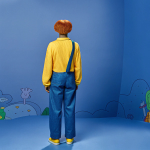 Back view of a character from Total Drama series. Standing in a colorful, animated background.