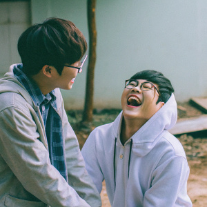 L.Joe and Chunji from the music group Teen Top are laughing and making funny faces during a photo shoot.
